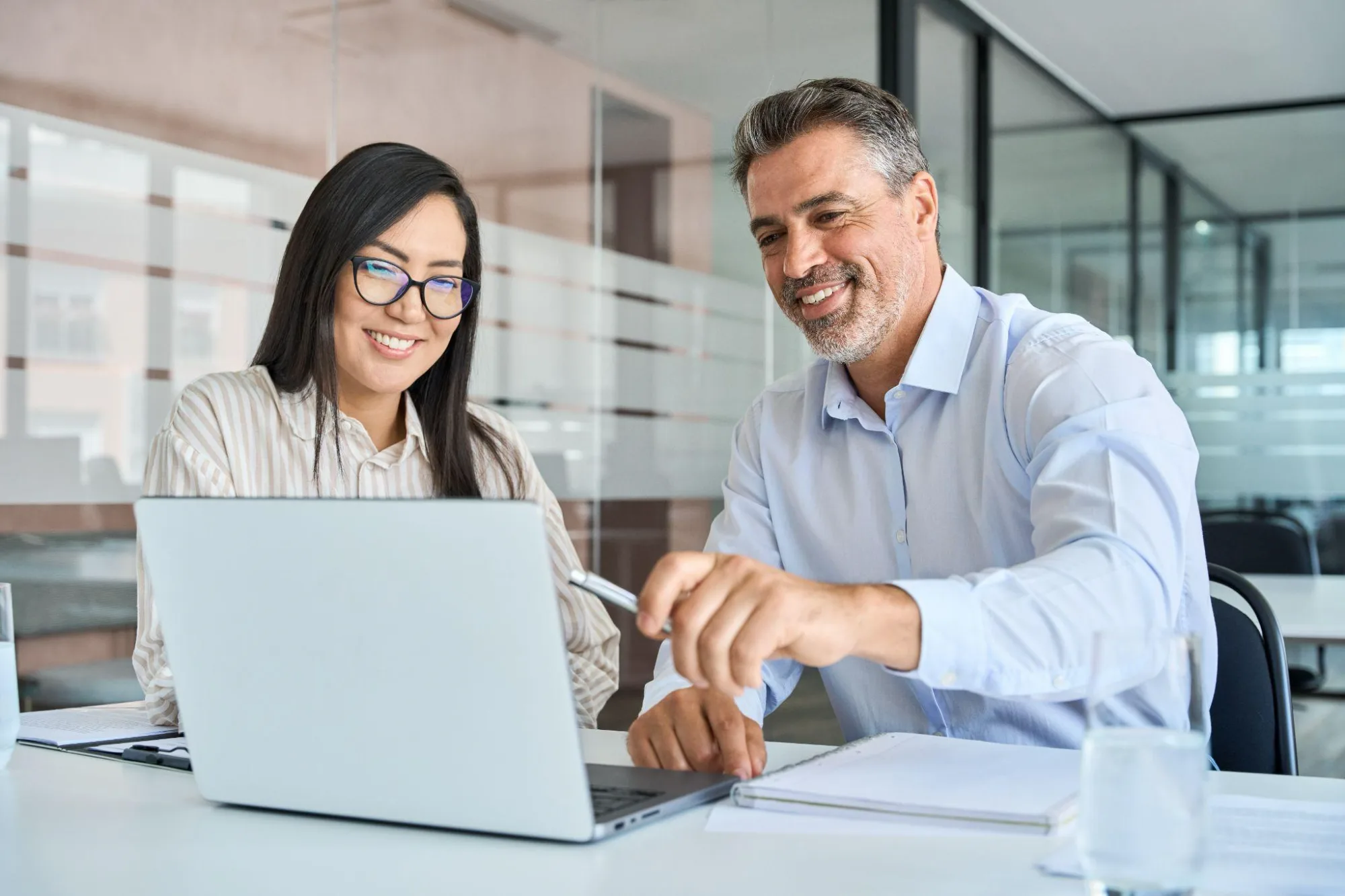 A professional adviser collaborating with an executive client at a boardroom table