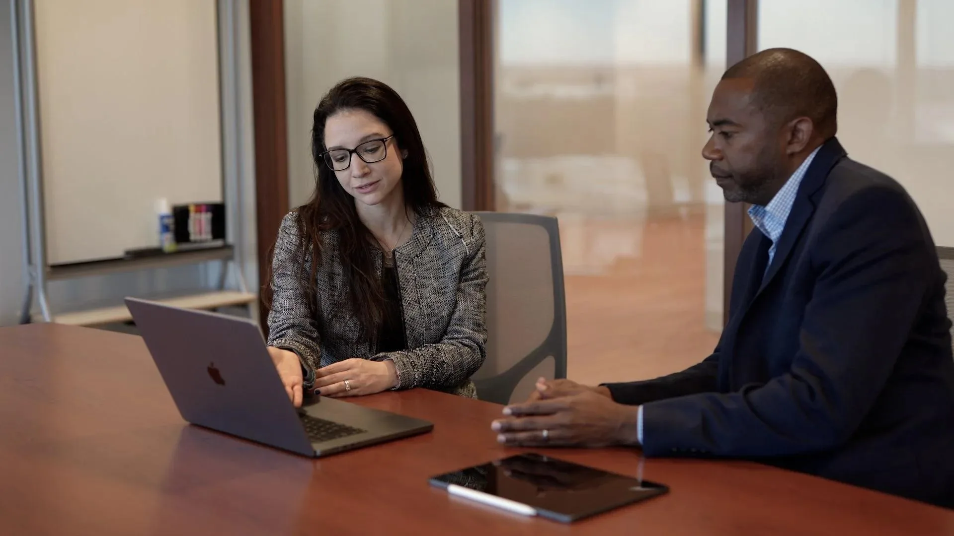 A governance adviser working through findings with an executive client